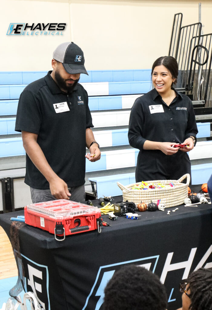 The Hayes Electrical team engages with the community, demonstrating electrical components and tools at a local event.
