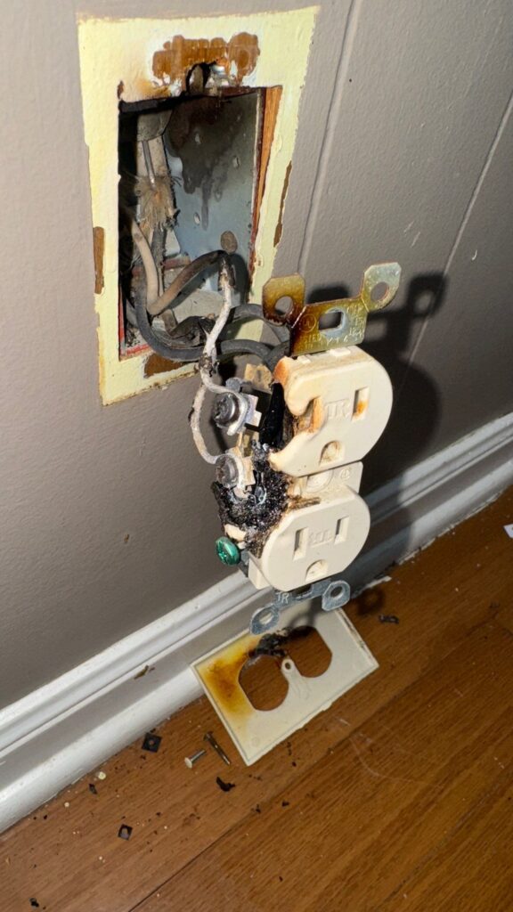 Diagnosing and safely repairing a severely burnt electrical outlet and wiring to restore power and ensure safety in a residential home.