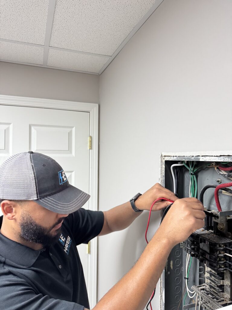 Our skilled electrician performs thorough diagnostics on an electrical panel, ensuring safe and reliable power for your business.