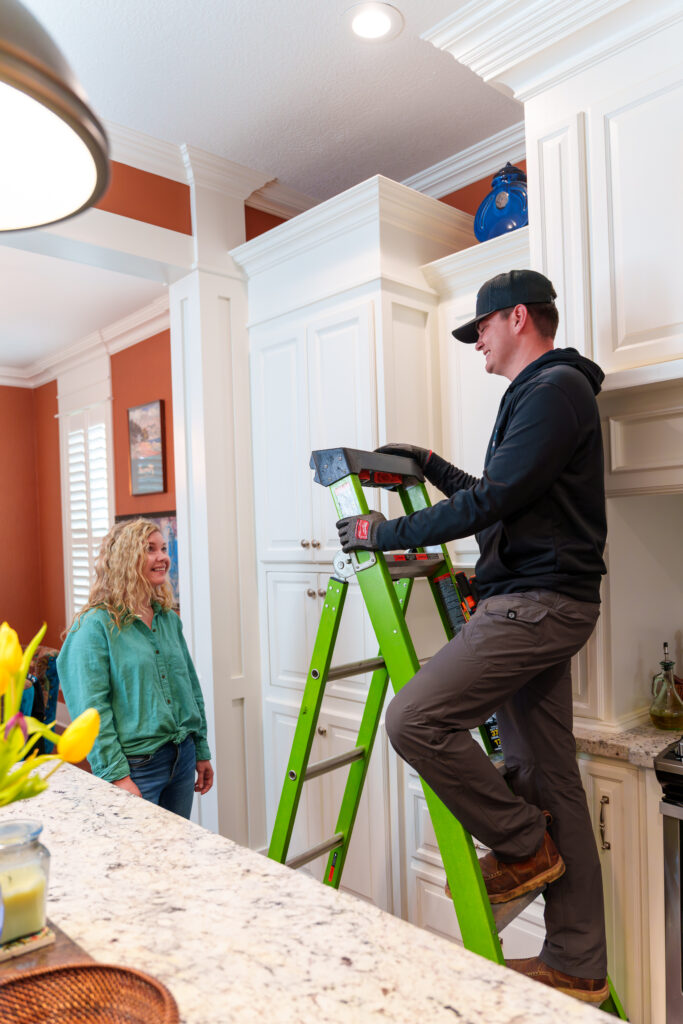 A Hayes Electrical technician consults with a homeowner during a residential service call, ensuring customer satisfaction.