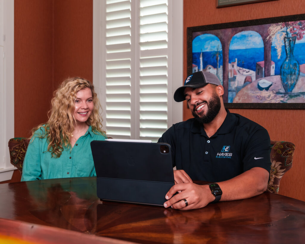 A Hayes Electrical team member discusses project details with a residential customer.