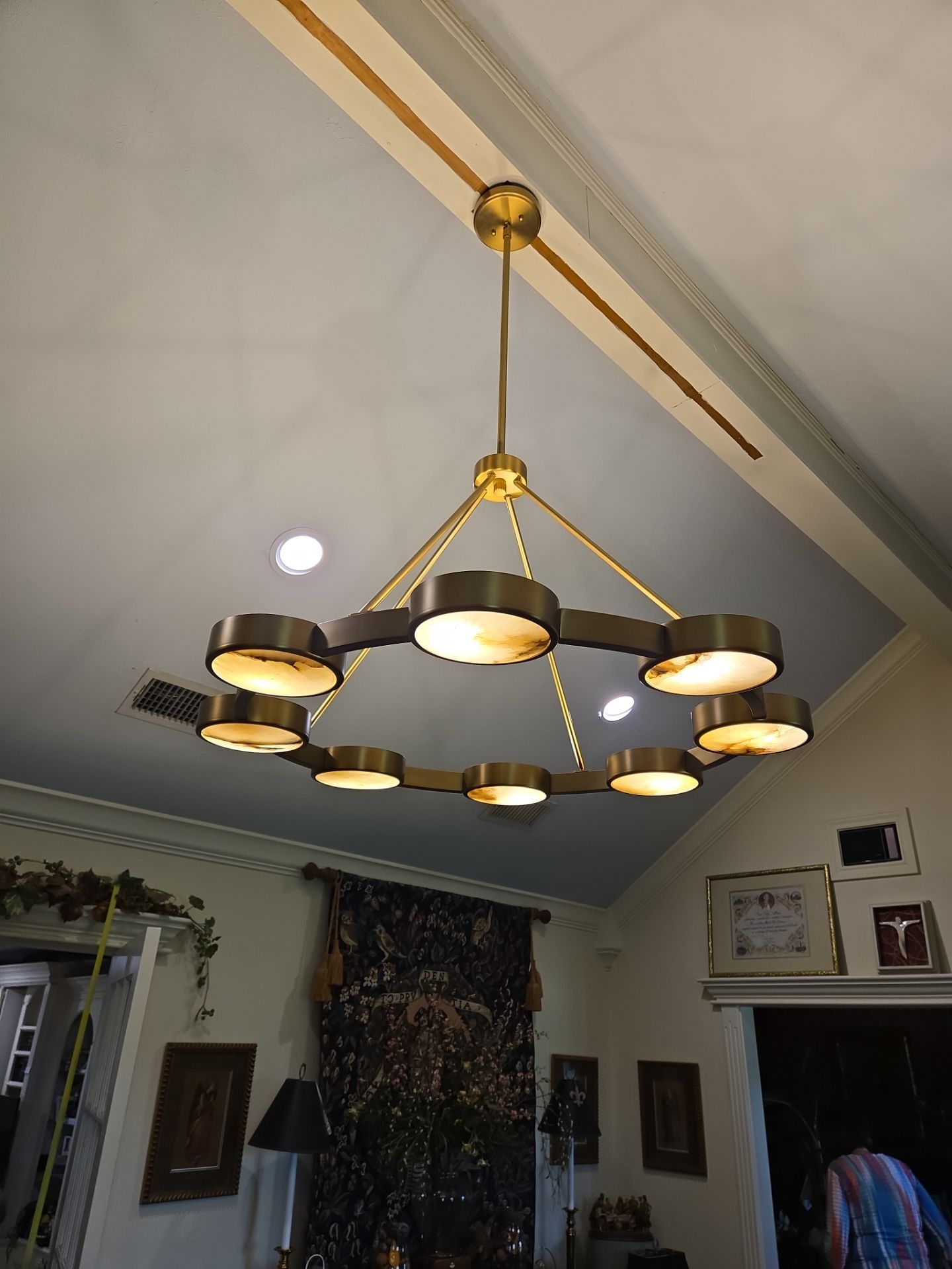 Expertly installing a stylish chandelier and recessed lighting to illuminate a beautiful residential space.