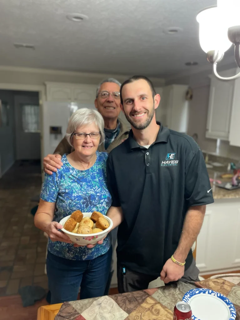 A Hayes Electrical team member shares a friendly moment with customers in their Lake Charles home.